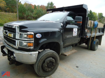 Chevrolet Silverado 6500HD dump truck with V-plow showing front grille and cab side