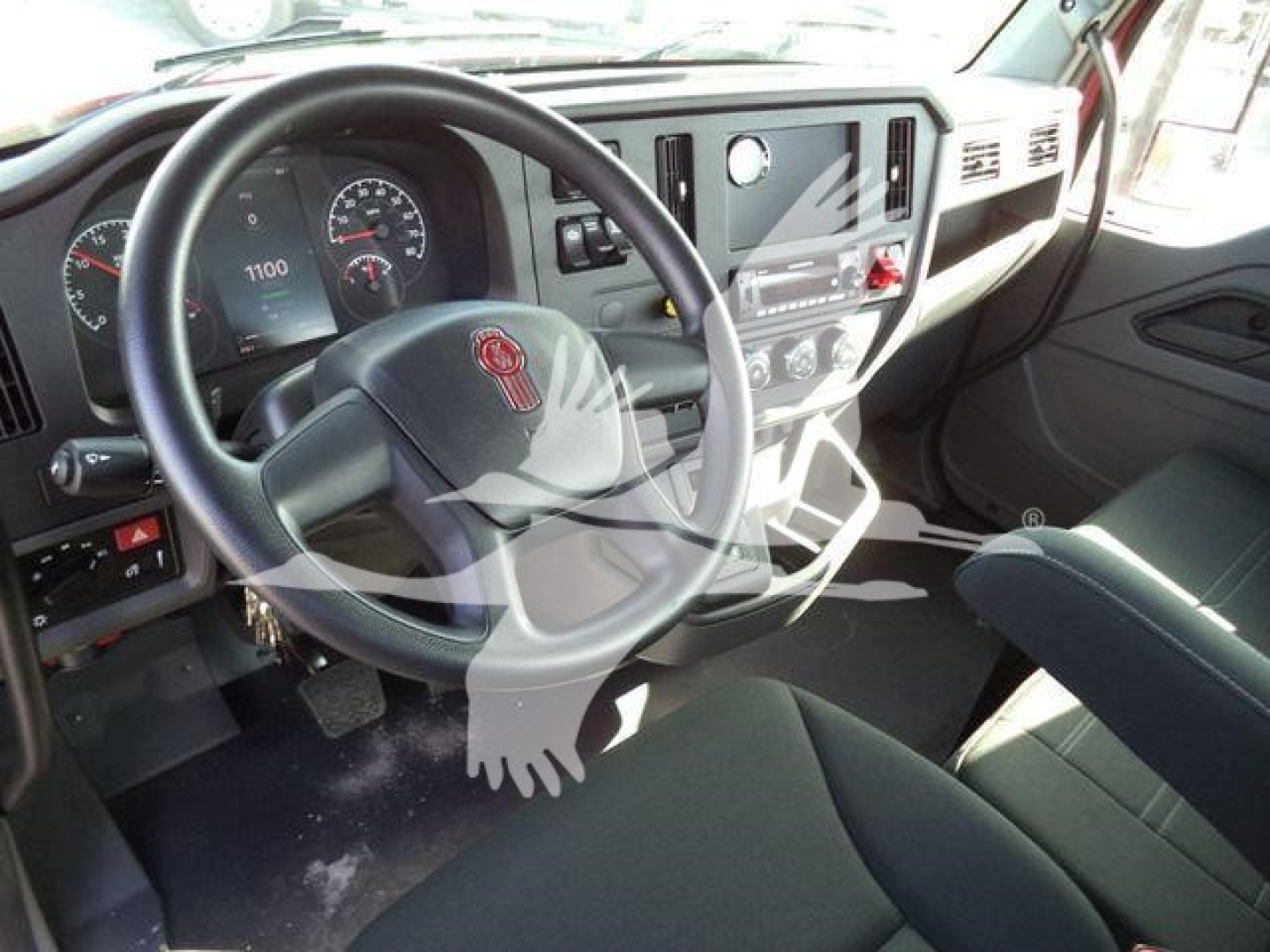 Kenworth T280 interior view showing steering wheel and dash, with gauge cluster and center console visible.