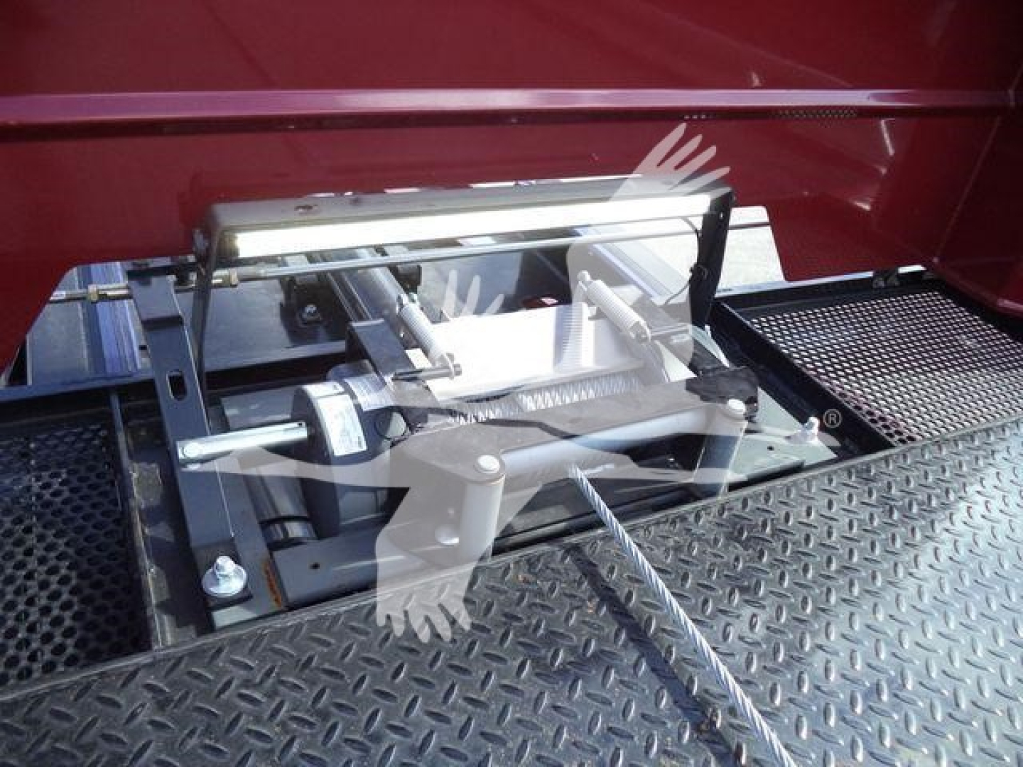 Landing gear mechanism and platform of a rollback truck with metal diamond plate surface.