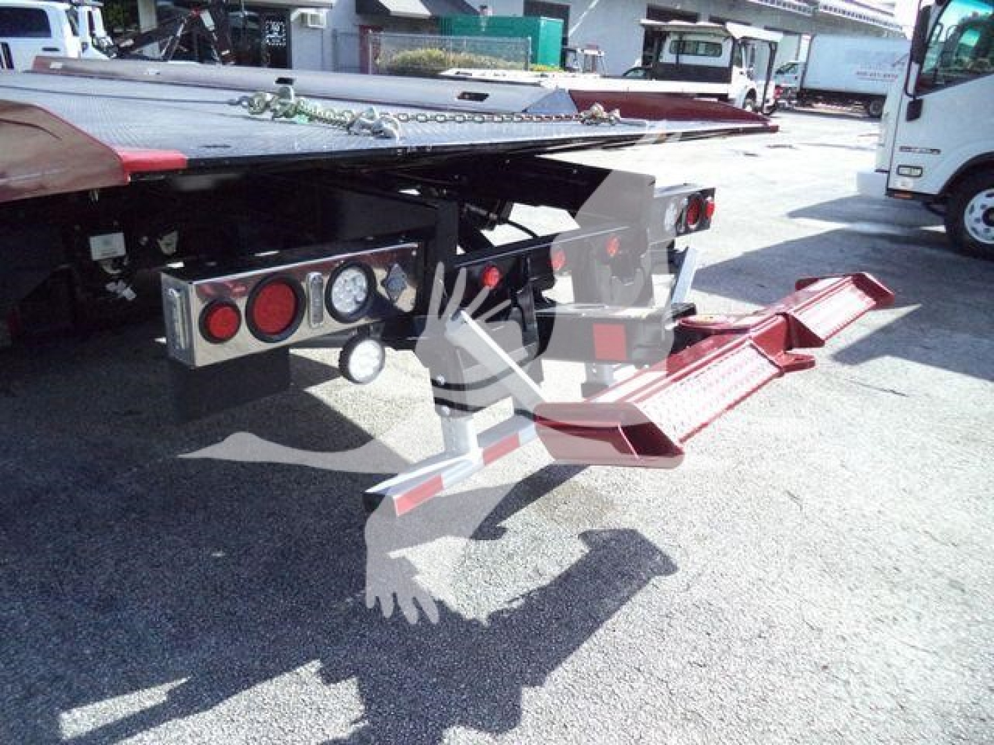 Kenworth T280 rollback truck rear view showing tow hitch and loading ramps.