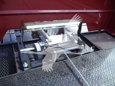 Landing gear mechanism and platform of a rollback truck with metal diamond plate surface.