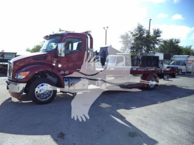 Kenworth T280 rollback truck side view showing cab and long wheelbase chassis with chrome wheels.