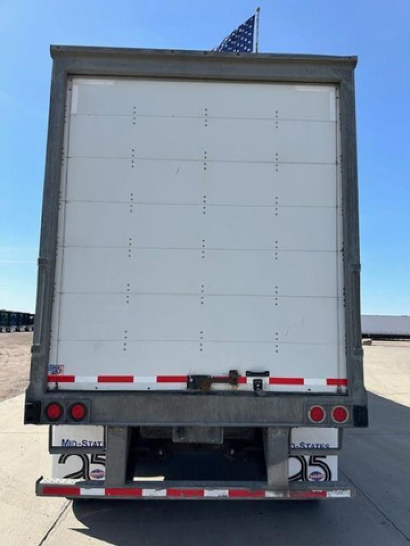 Rear view of a 2016 Wabash trailer showing a white closed box with rear doors, bumper, and reflector lights.