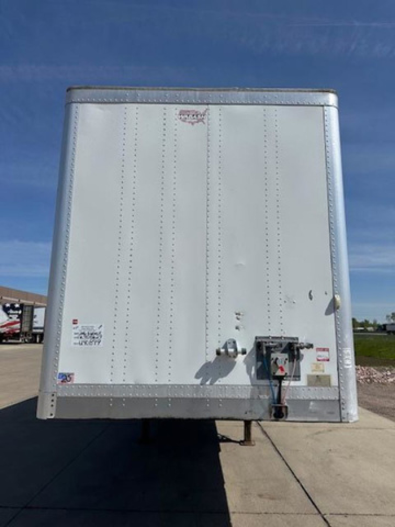 Rear view of a 2016 Wabash box trailer showing rear doors and hitch with safety chains and electrical connections.