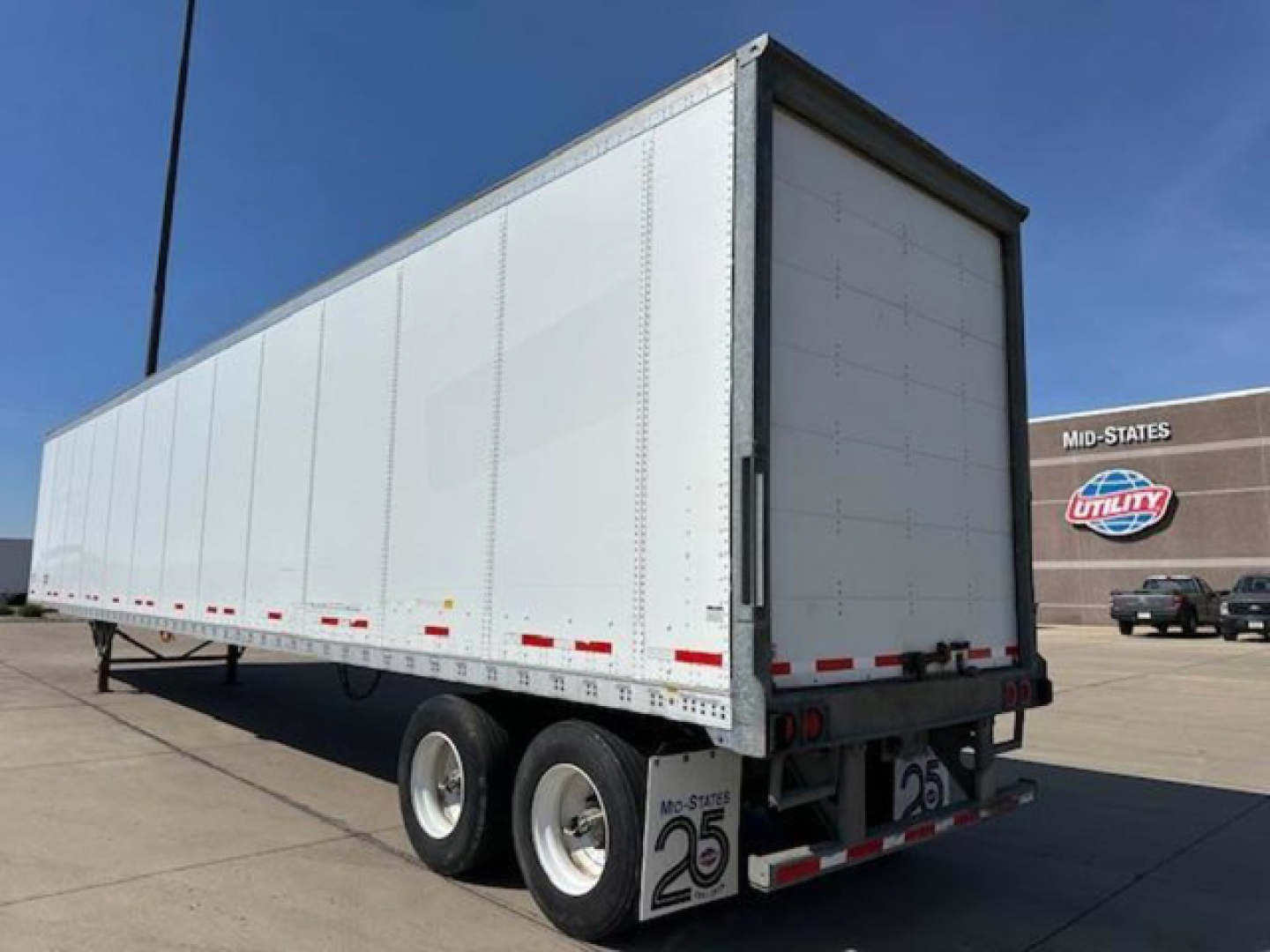 Trailer showing rear and side panels with 2-axle wheels and standard box trailer with rear doors.
