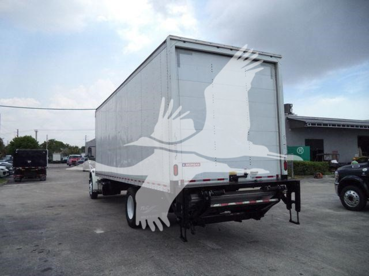 Box truck rear view showing Freightliner M2 106 cargo box and undercarriage with rear bumper and taillights