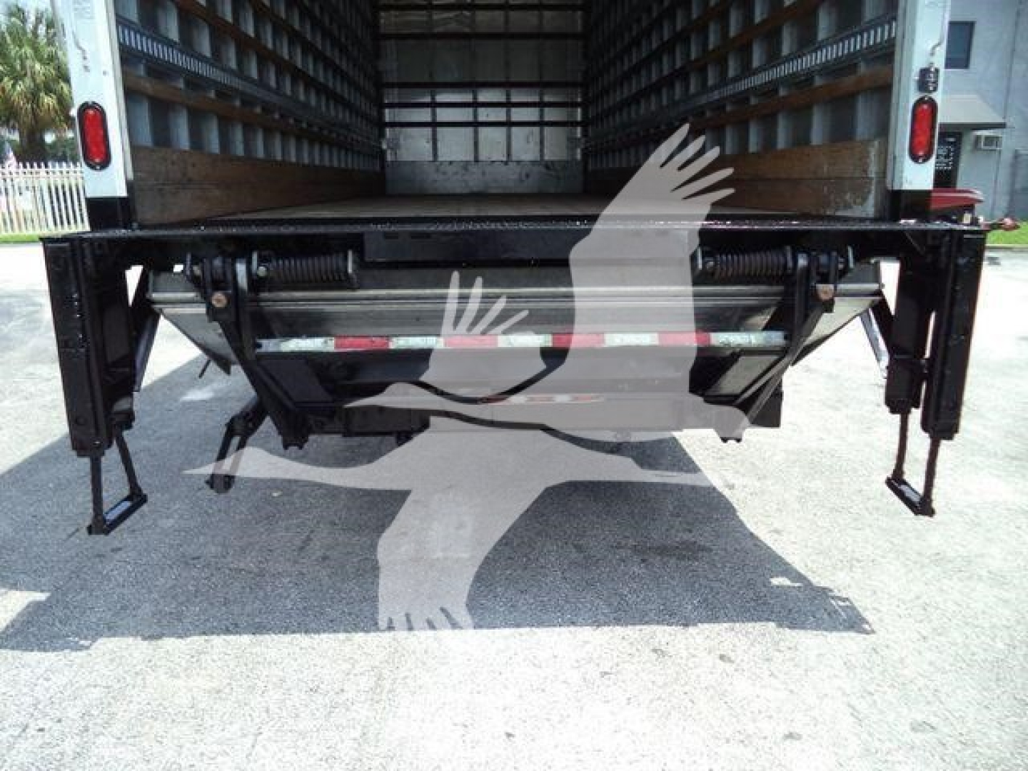 Freightliner M2 106 rear view showing lifting gates and undercarriage components.