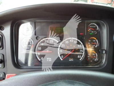 Dashboard of a Freightliner M2 106 showing speedometer, tachometer, and gauges inside a truck cabin.