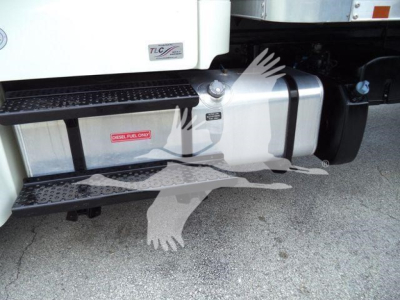 Truck side near fuel tank and steps showing DPF fuel label and stainless tank on Freightliner M2 106 engine bay area