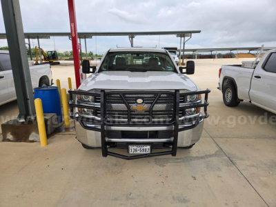 Front view of a white 2017 Chevrolet Silverado 2500 with black grille guard and bumper, visible Chevy bowtie emblem, and Texas license plate.