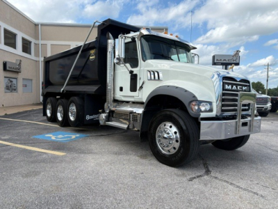 Dump truck showing Mack GR84F dump bed and front grille with chrome bumper.