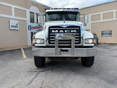Mack GR84F dump truck front view showing large grille with MACK lettering and heavy front bumper.