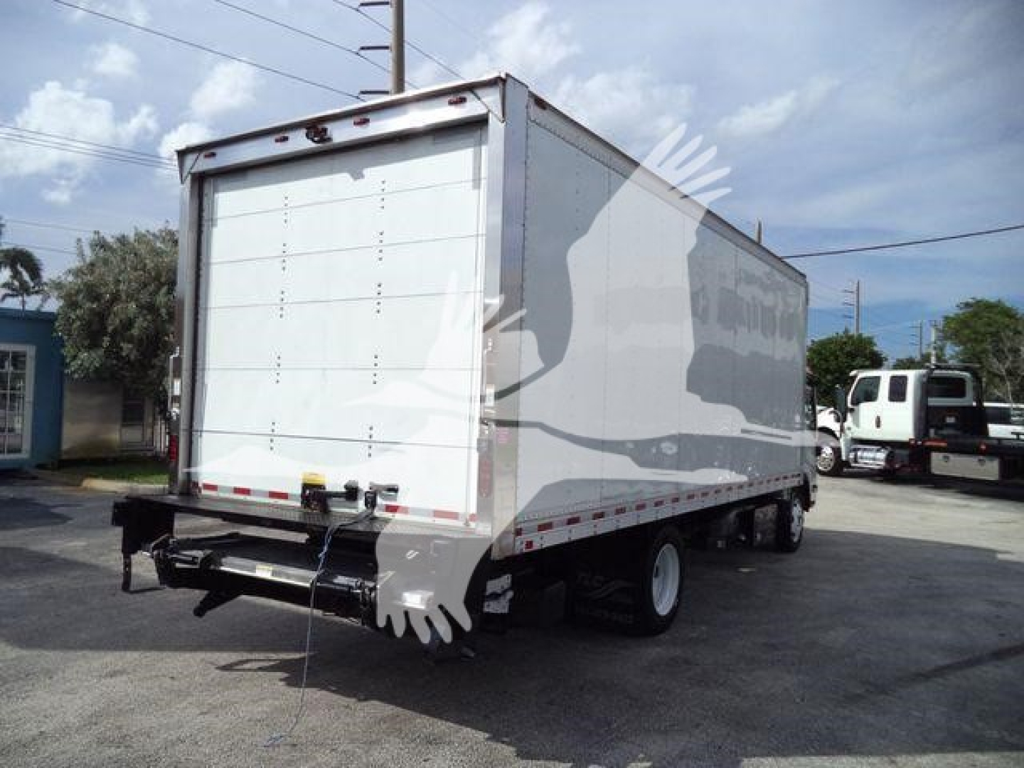 Isuzu box truck rear view with white cargo area and bumper, stock content not legible in image.