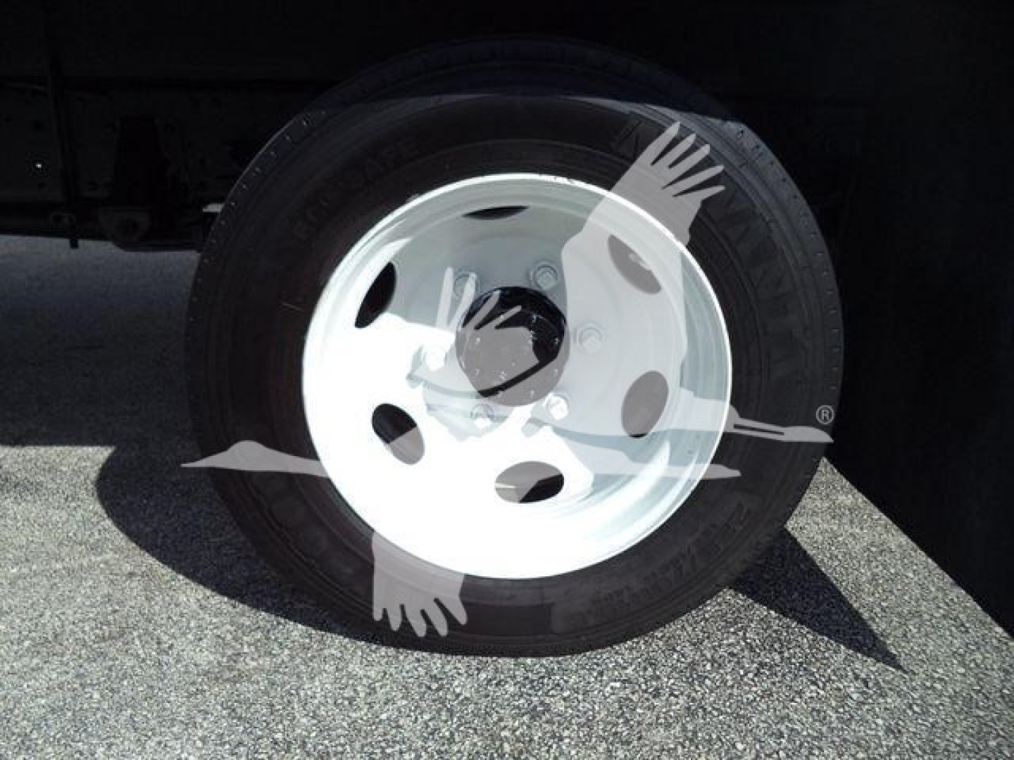 Isuzu truck wheel with white steel rim and black tire; no additional text visible.