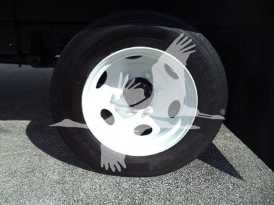 Isuzu truck wheel with white steel rim and black tire; no additional text visible.