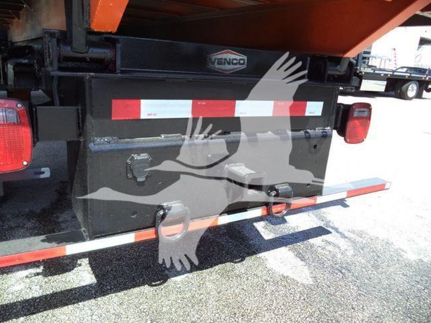 Truck chassis rear showing toolbox with Venco sticker and taillights and rear underride guard.
