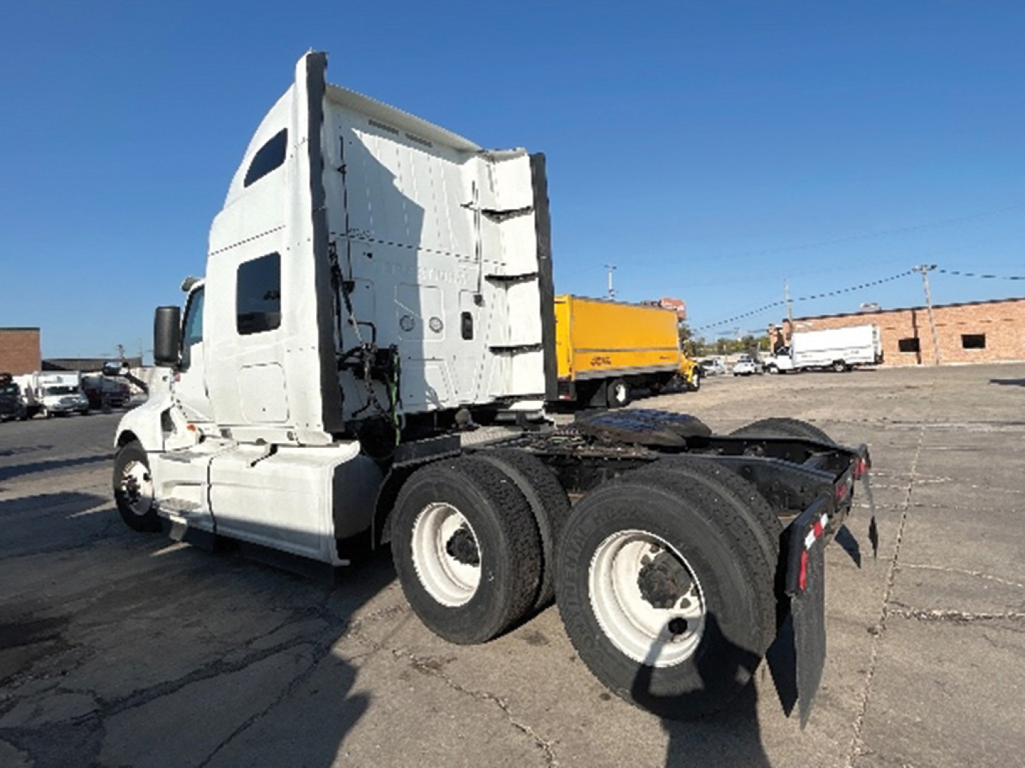 International LT625 tractor truck chassis with sleeper cab, rear view showing dual rear axles and fifth wheel area.