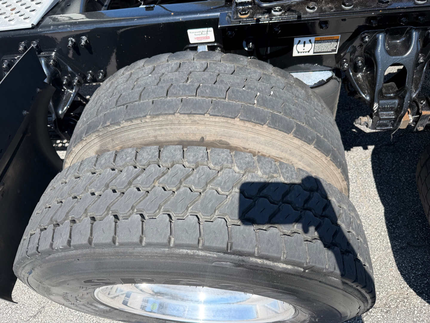 Kenworth T680 truck chassis showing dual rear tires and wheel rims with tread visible