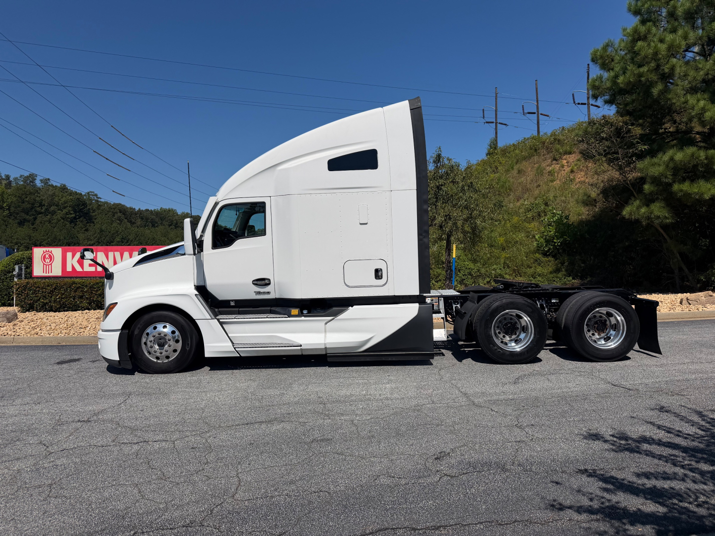 Kenworth T680 2023 conventional sleeper tractor side view showing tractor cab and dual rear axles.
