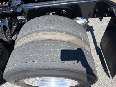 Kenworth T680 truck chassis showing dual rear axles with exposed tires and wheel rims