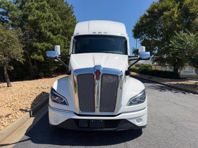 Kenworth T680 front view showing bold grille, headlights, and hood. No visible text on the truck body in this image.