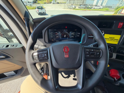 Kenworth T680 dash and steering wheel interior view showing instrument cluster and steering wheel with Kenworth emblem.