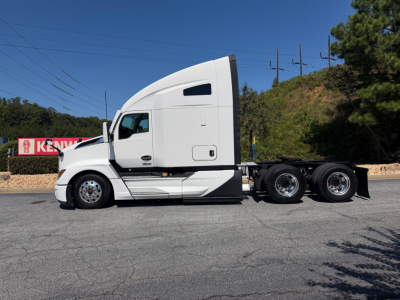 Kenworth T680 2023 conventional sleeper tractor side view showing tractor cab and dual rear axles.