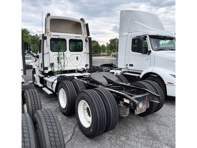 Freightliner Cascadia125 chassis view showing rear fifth-wheel area and dual rear axles with tires; white cab and trailer hookup visible.