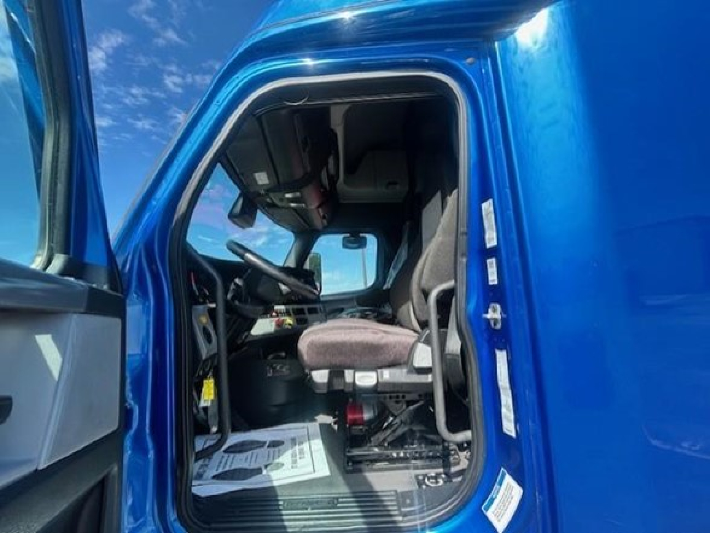 Freightliner Cascadia 126 truck cab interior view showing driver seat and dashboard.