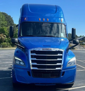 Freightliner Cascadia 126 front view showing blue exterior, grille, headlights, and mirrors.