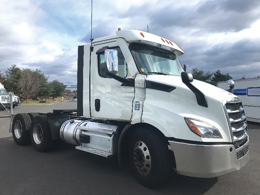 Freightliner Cascadia126 conventional daycab truck side view showing cab, fuel tanks, and front grille