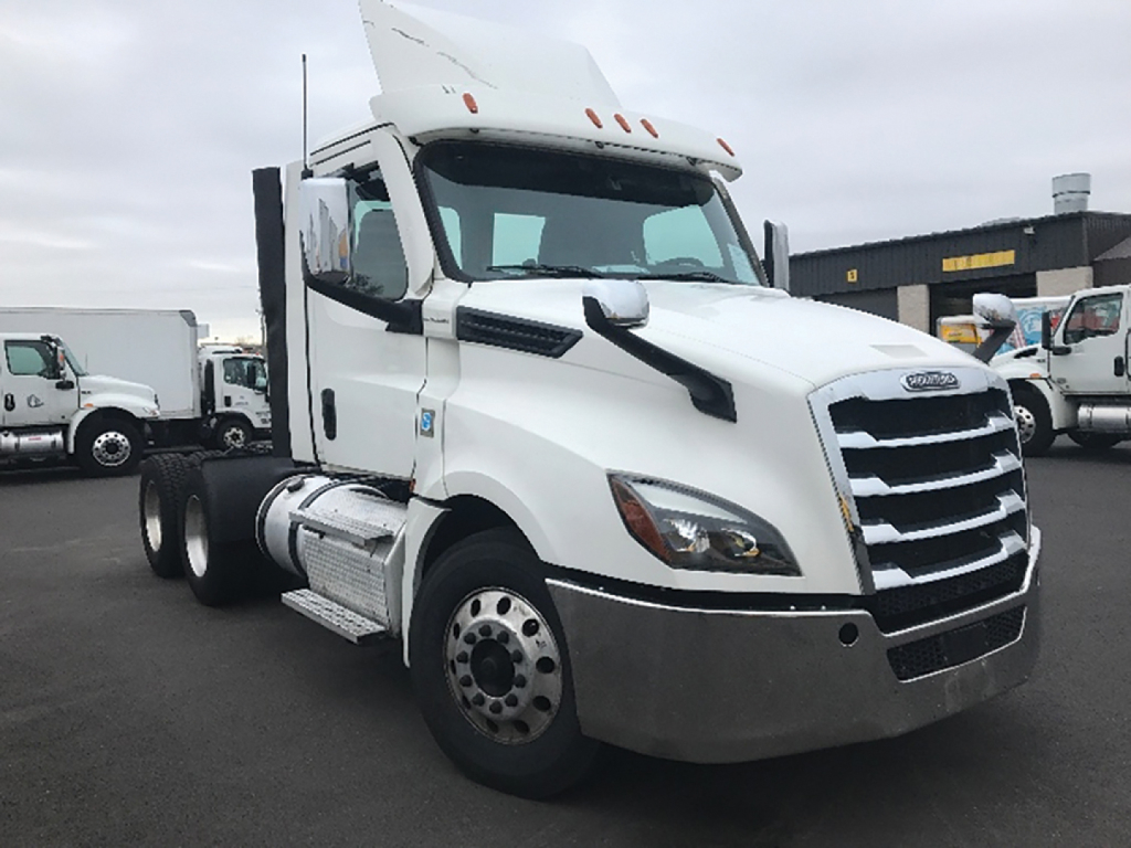 Freightliner Cascadia126 truck cab with white exterior, large chrome grille, dual exhaust stacks, and tanker-style fuel tanks; VIN and stock not visible on this tag.