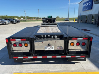 Trailer rear view showing flatbed equipment with lights and license plate area.