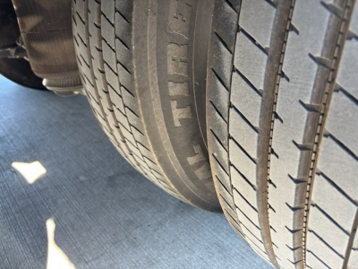 Trailer wheel area showing tires and tread pattern on a trailer wheel well.