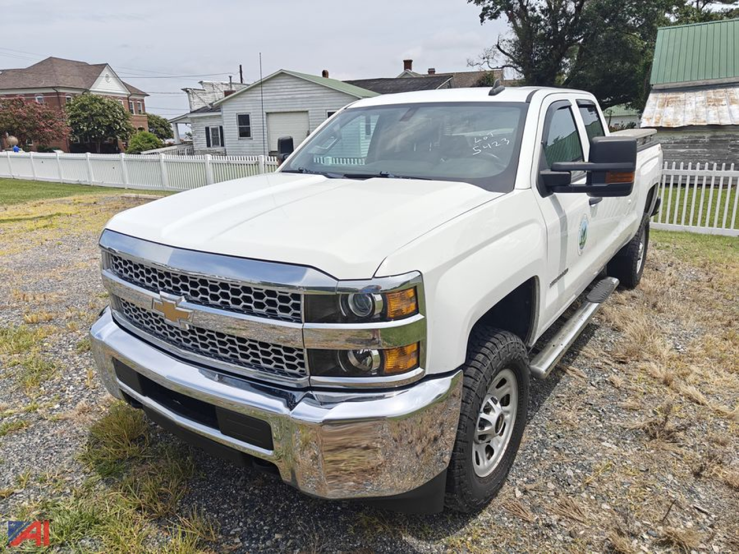 Chevrolet Silverado 2500HD pickup truck in white, extended cab, front three-quarter view showing chrome bumper and grille.