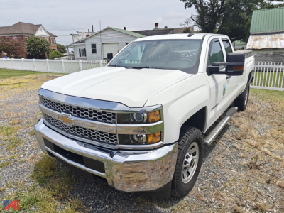 Chevrolet Silverado 2500HD pickup truck in white, extended cab, front three-quarter view showing chrome bumper and grille.