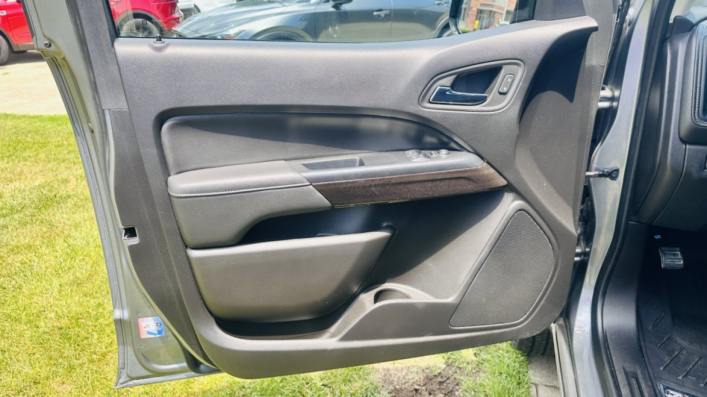 GMC Canyon 2021 interior door panel view with armrest and speaker grille