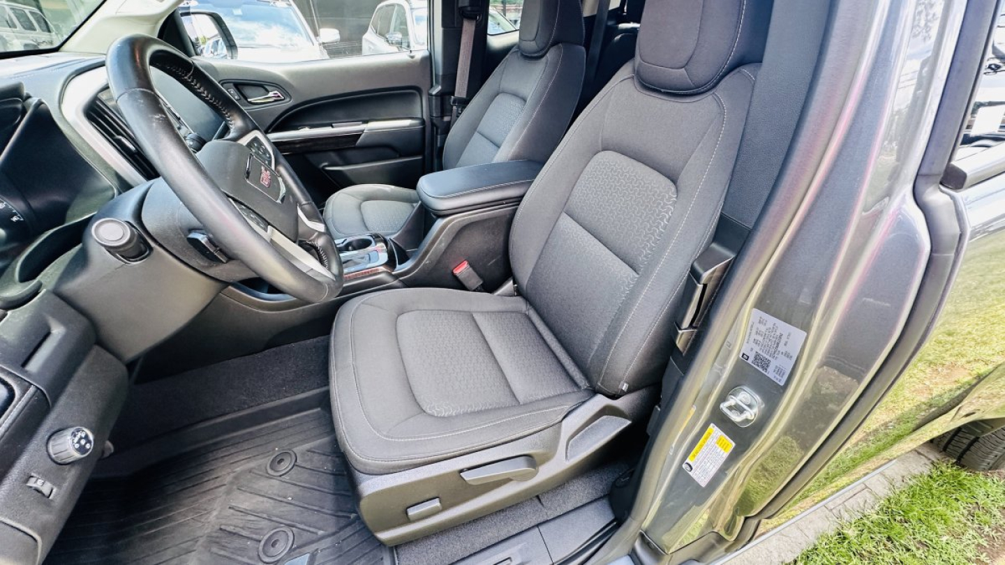GMC Canyon 2021 interior showing front seats and dashboard area from driver side.