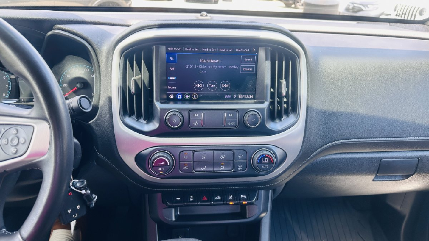 Dashboard area of a 2021 GMC Canyon showing infotainment screen and climate controls.