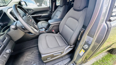 GMC Canyon 2021 interior showing front seats and dashboard area from driver side.