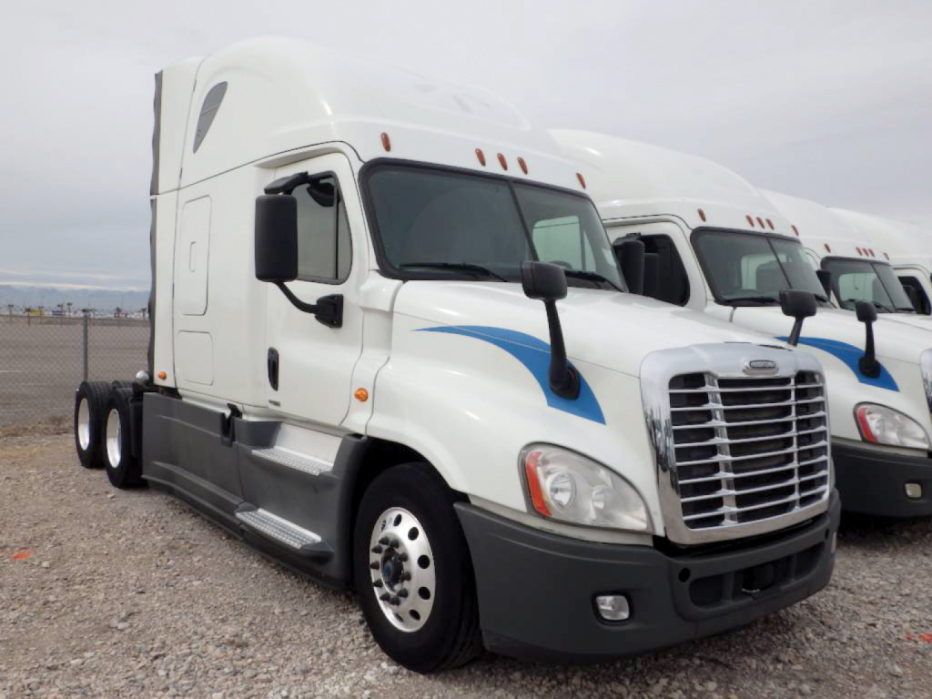 Freightliner Cascadia125 sleeper cab truck side view with white paint and blue trim; grill, headlights, side mirror, and front fender visible.
