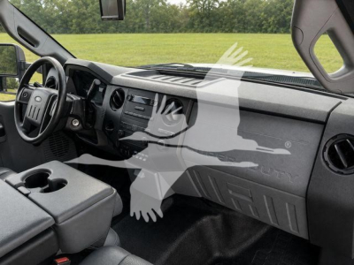 Dashboard and front interior of a Ford F-450 truck cab with steering wheel on left, center console, and glove compartment visible.