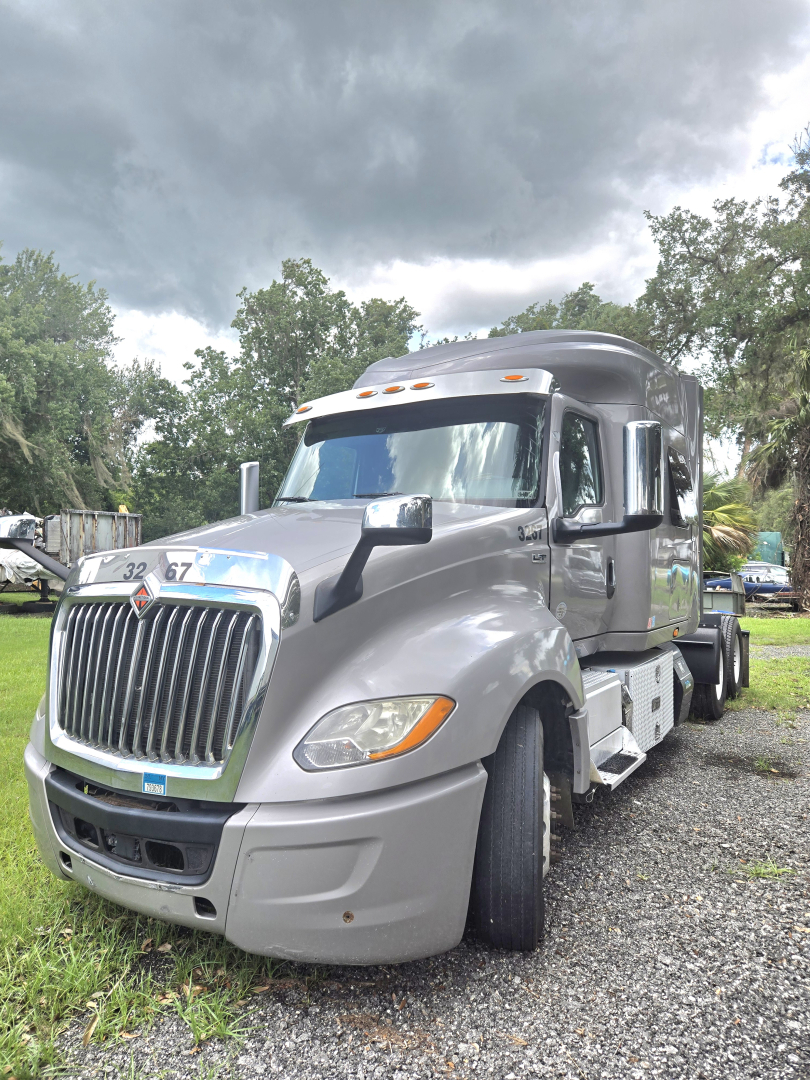 Truck image of a 2019 International LT625 condo sleeper showing front and side view with chrome grille, large headlights, and dual rear axles.