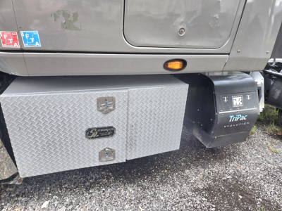 Truck side with diamond plate toolbox and ProTech fuel or storage box beneath cab, displaying LT625 condo theme; visible labels and compartments.