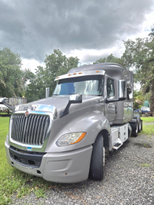 Truck image of a 2019 International LT625 condo sleeper showing front and side view with chrome grille, large headlights, and dual rear axles.