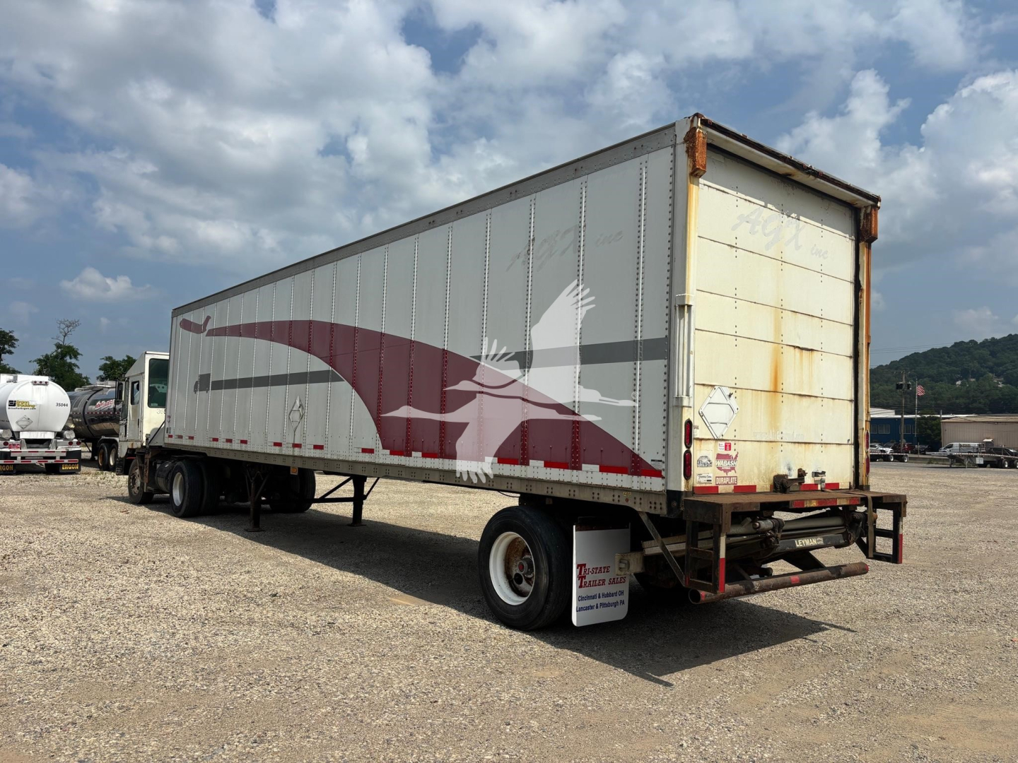 Wabash trailer showing side graphics and rear doors, used condition, VIN sticker visible on back.