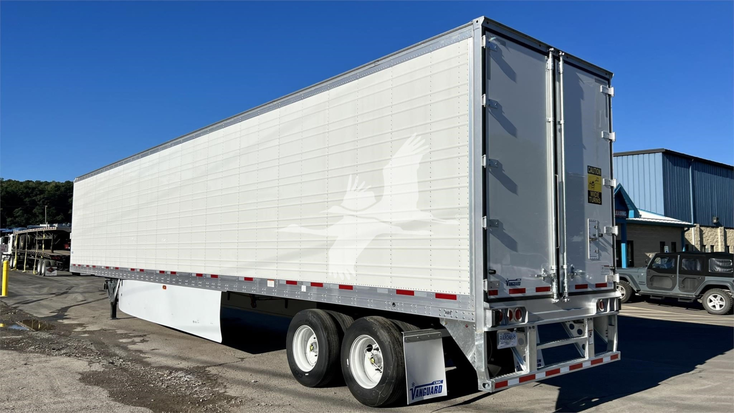 Trailer side and rear showing a Vanguard Cool Globe reefer trailer with white panels, dual rear doors, and dual rear axles.
