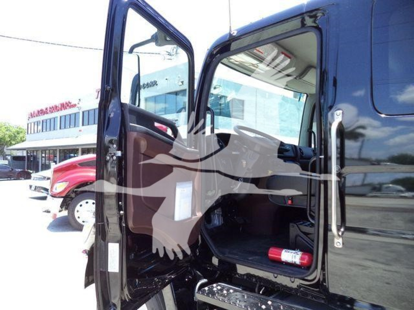 Truck cab interior with open door showing Rollback truck, 2026 Hino L6, VIN 5PVNJ7ET5T5T50133, stock J50133.