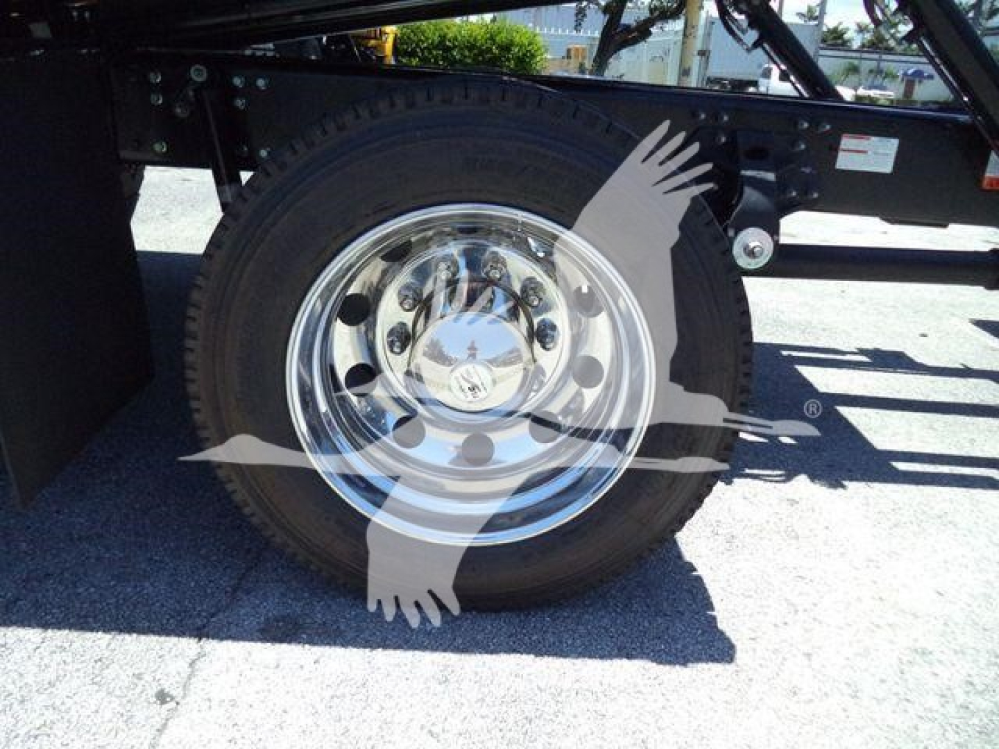 Truck wheel and chassis showing chrome wheel with tire; no other readable text visible on image.