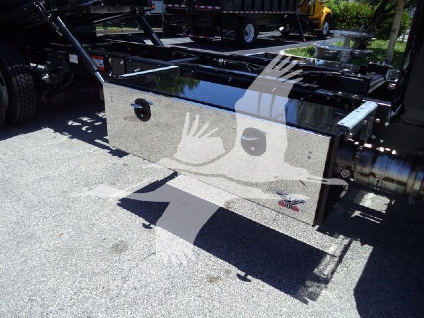 Hino L6 rollback truck chassis toolbox with polished metal storage chest and hydraulic lines in view.